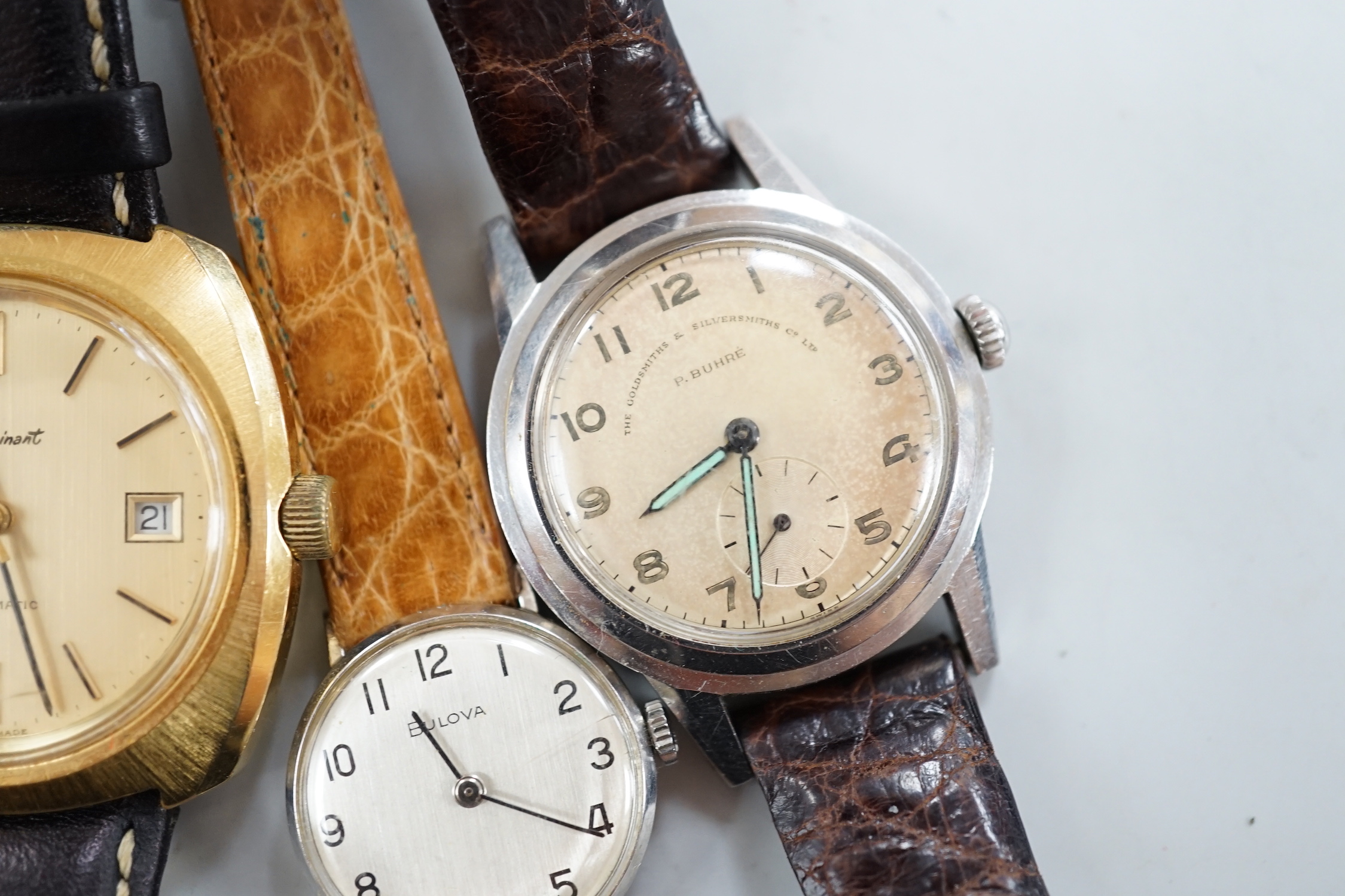 Three assorted gentleman's steel or gilt wrist watches, including retailed by Buhre and a lady's steel manual wind Bulova watch.